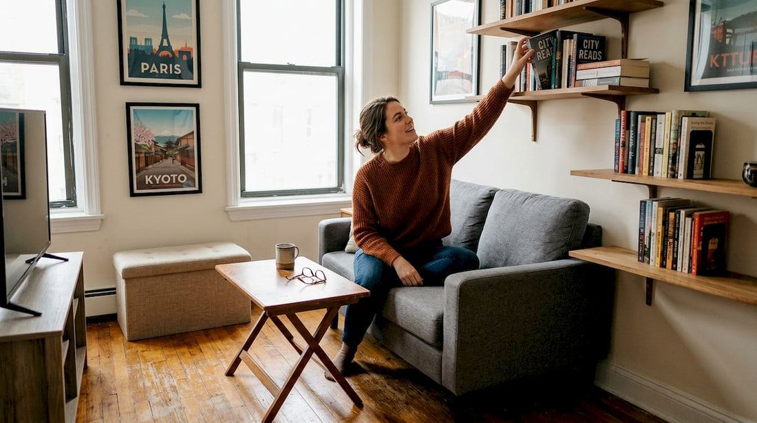 Woman reaching for book in compact living room
