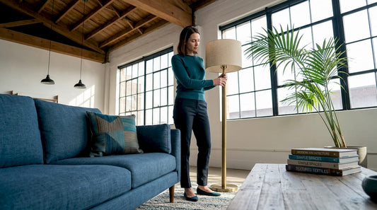 Woman adjusting lamp in mixed-style living room