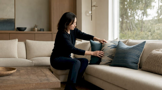 Woman arranging pillows in transitional style living room