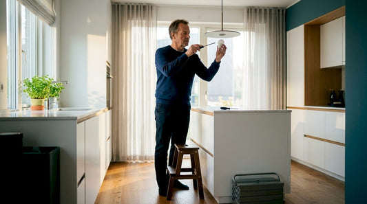 Man upgrading home lighting with LED bulb